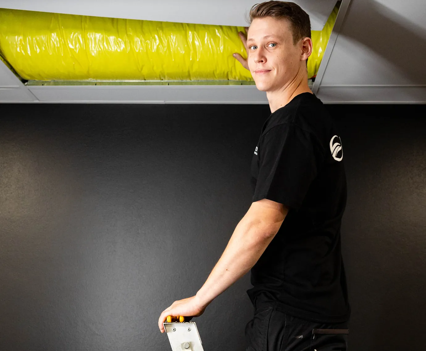 Hycool electrician working in a ceiling space
